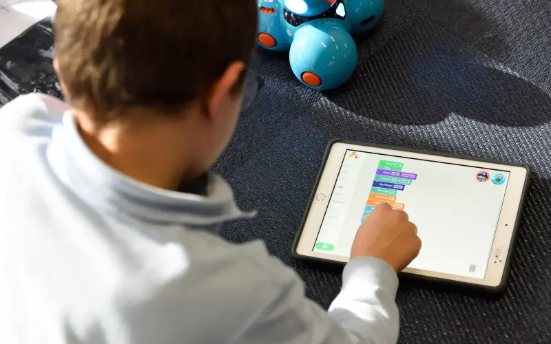 boy learning coding through toys