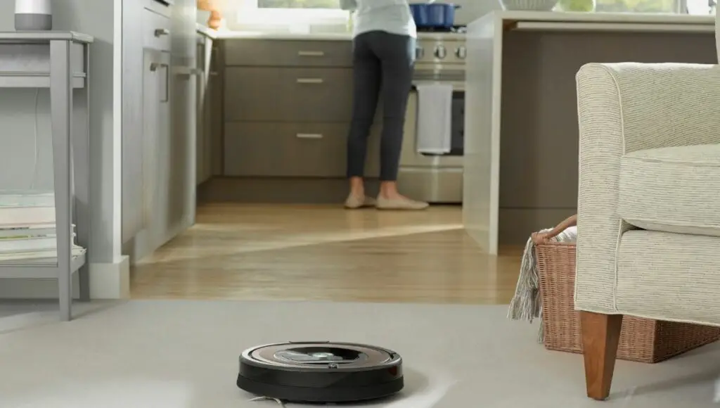 The Roomba 690 with the Google Home Assistant speaker in the background
