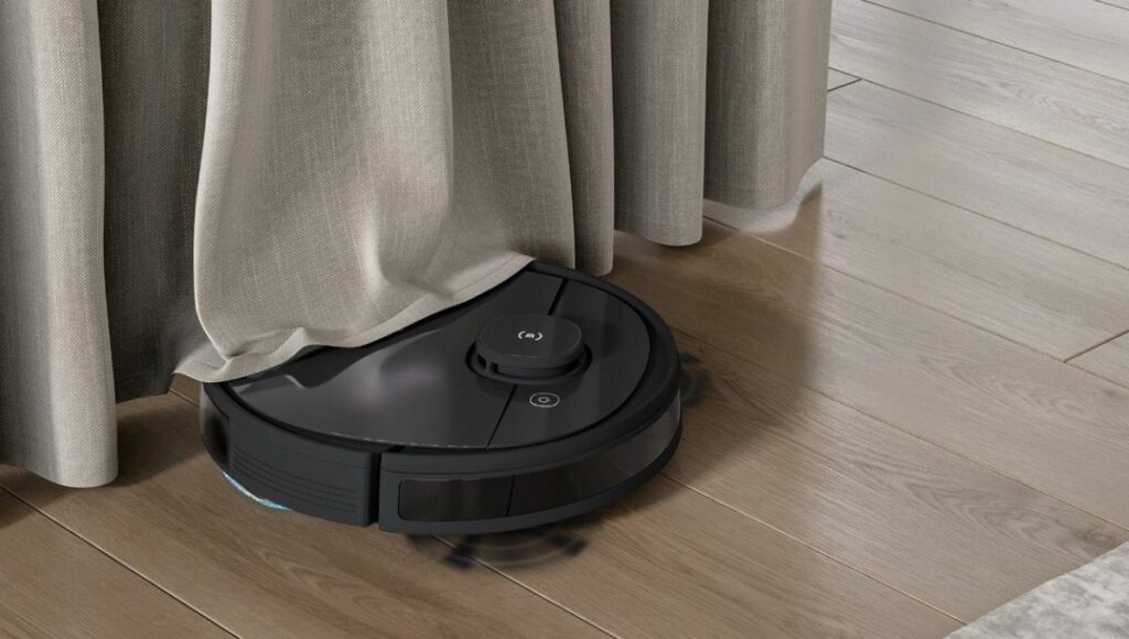 The Ozmo t5 robotic vacuum cleaner cleaning under a curtain