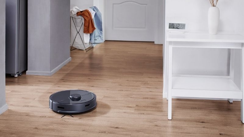 The Roborock s5 MAX mopping a wooden floor