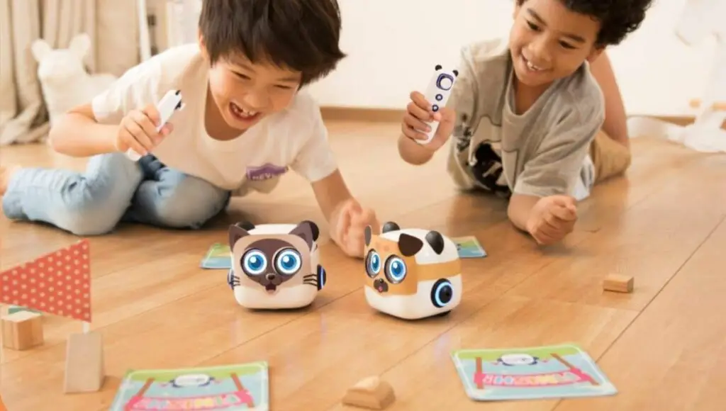 Two kids play with their cute mTiny robot toy