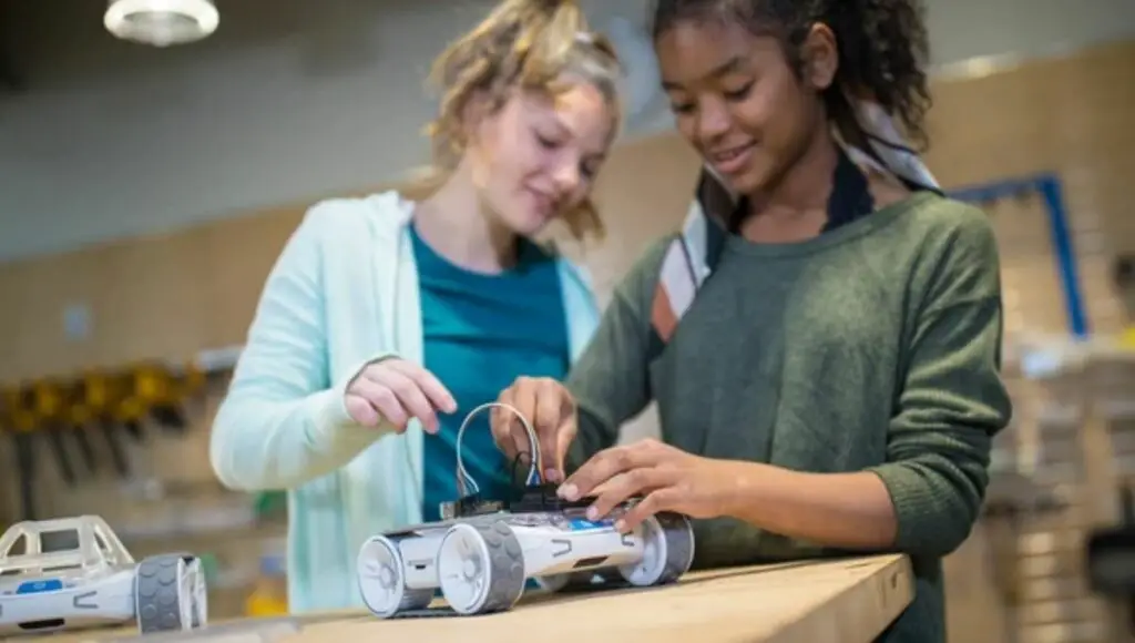 Two young girls setup a sphero rvr robot