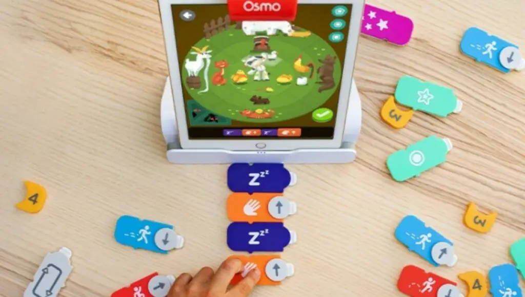 A kid connecting coding puzzles of osmo coding starter kit games