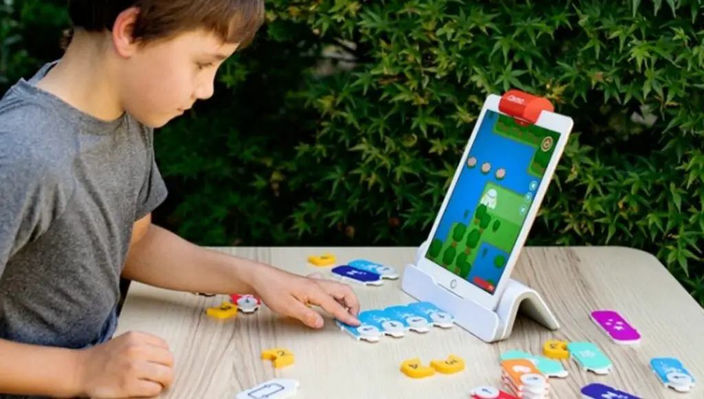A little boy playing with osmo coding starter kit