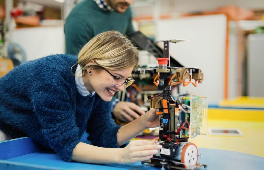 A lady building a robot