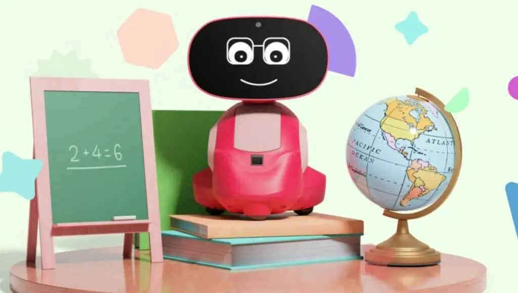 Miko 3 educational robot sit on to the books