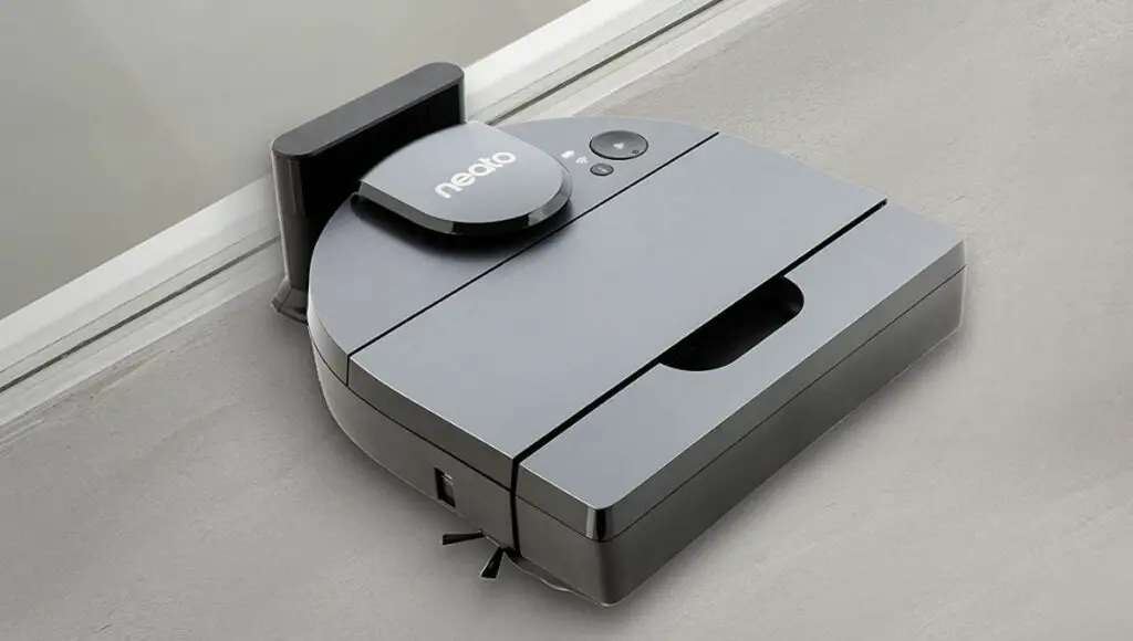 A neato d10 robot vacuum is being charged at the charge station