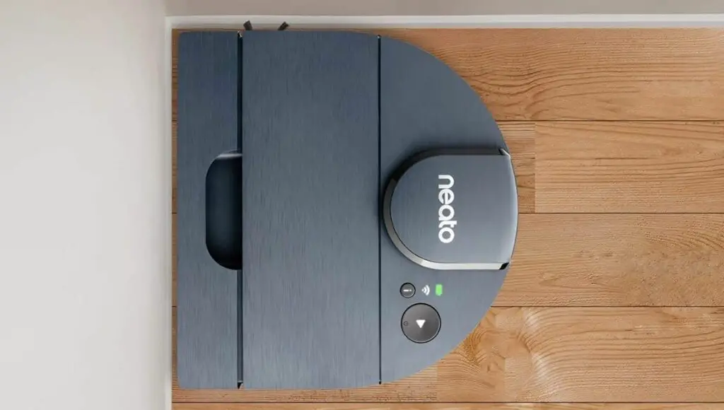 Neato D8 robot vacuum working in a room corner