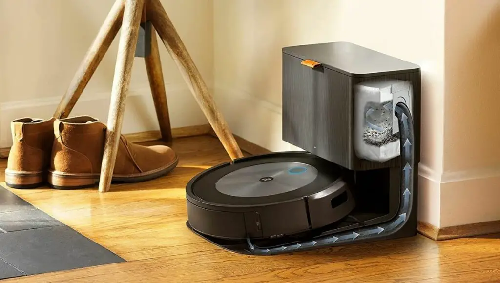 iRobot Roomba j7+ robot vacuum emptying itself into the cleaning base automatic dirt disposal with enclosed bags