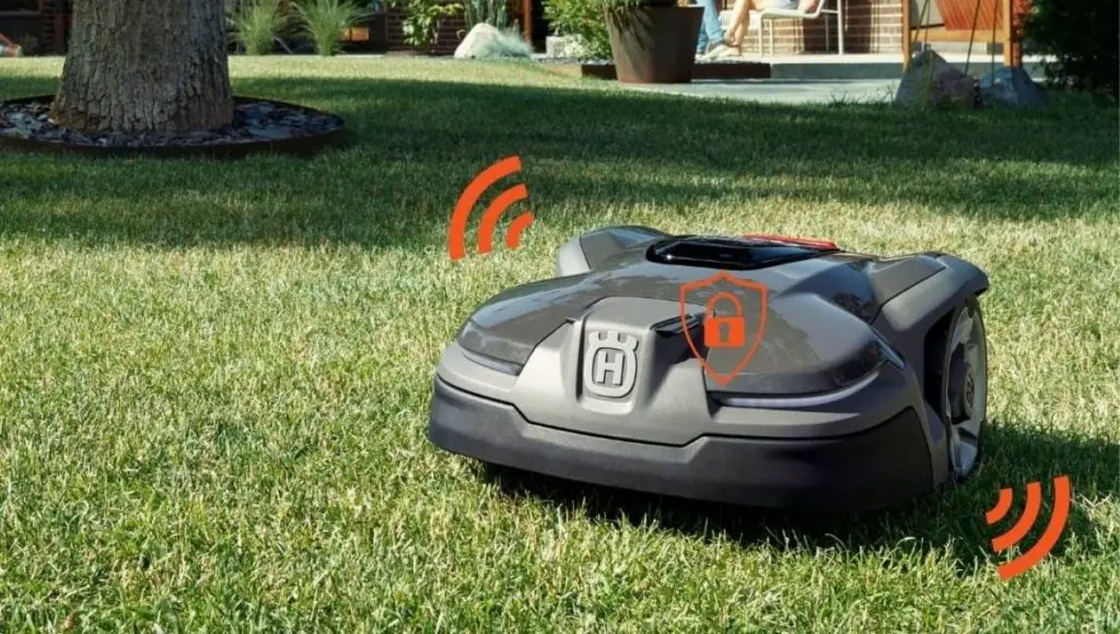 An automated anti-theft robot lawn mower is cutting grass in the garden