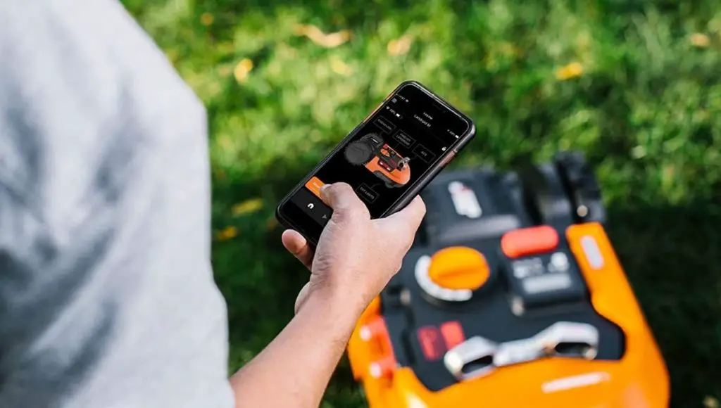 A man setup a anti-theft protection app of robotic lawn mower
