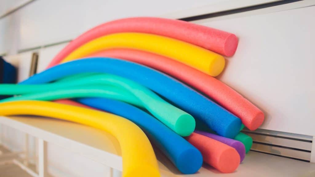 many colorful pool noodles