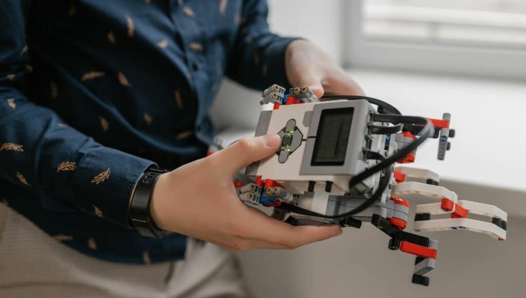 Close-up shot of a person holding a lego mindstorm