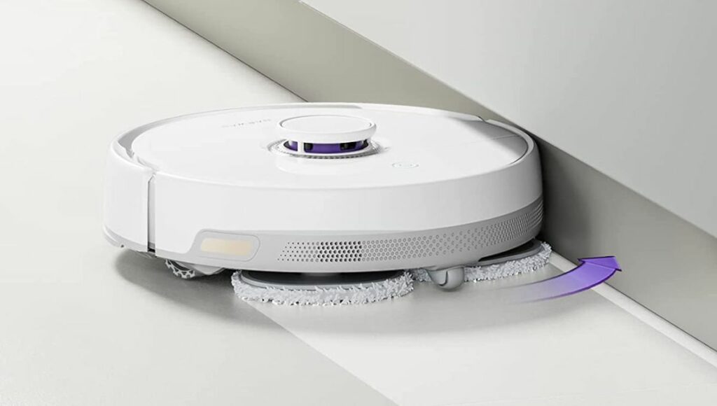 A Narwal Freo robot vacuum and mop doing deep cleaning in walls corners and floor