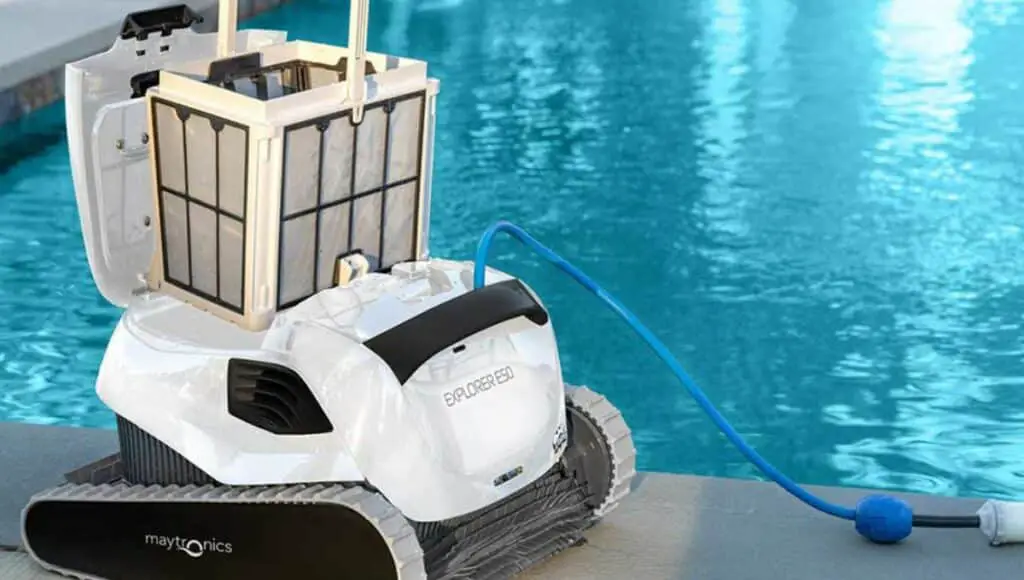 A dolphin explorer E50 beside a pool with a filter on it connected to a hose