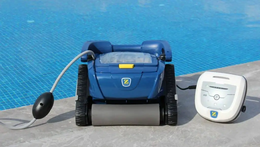a robotic pool cleaner beside a pool